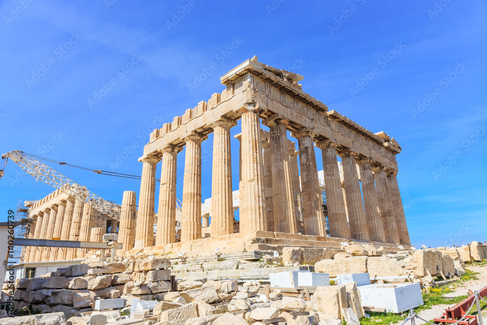 Parthenon on the Acropolis of Athens in summer, Greece. Ancient Greek Parthenon is the main landmark of Athens. Beautiful view of the famous temple ruins on the top of hill in Athens center.