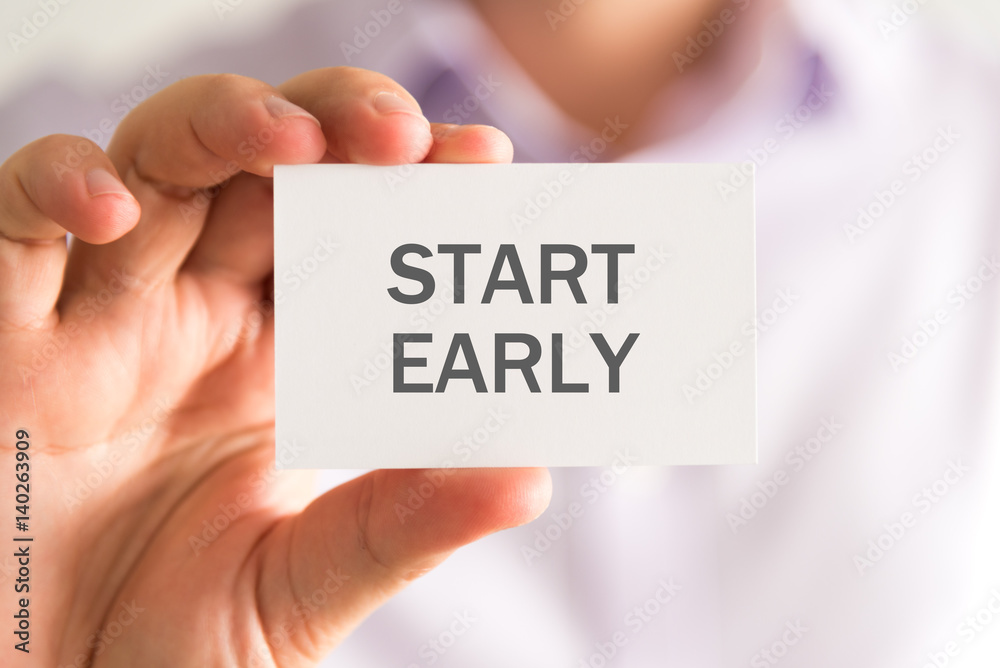 Businessman holding a card with START EARLY message