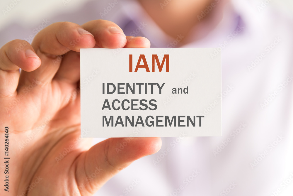 Businessman holding a card with IAM IDENTITY AND ACCESS MANAGEMENT message