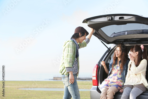 Young Man Talking to Two Women