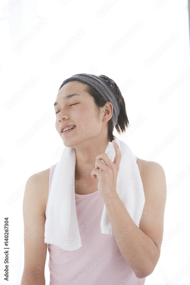 Young Man with Headband Using Skincare Product Young Man with Headband Using Skincare Product