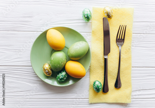 Easter concept. plate, fork, eggs on a white background