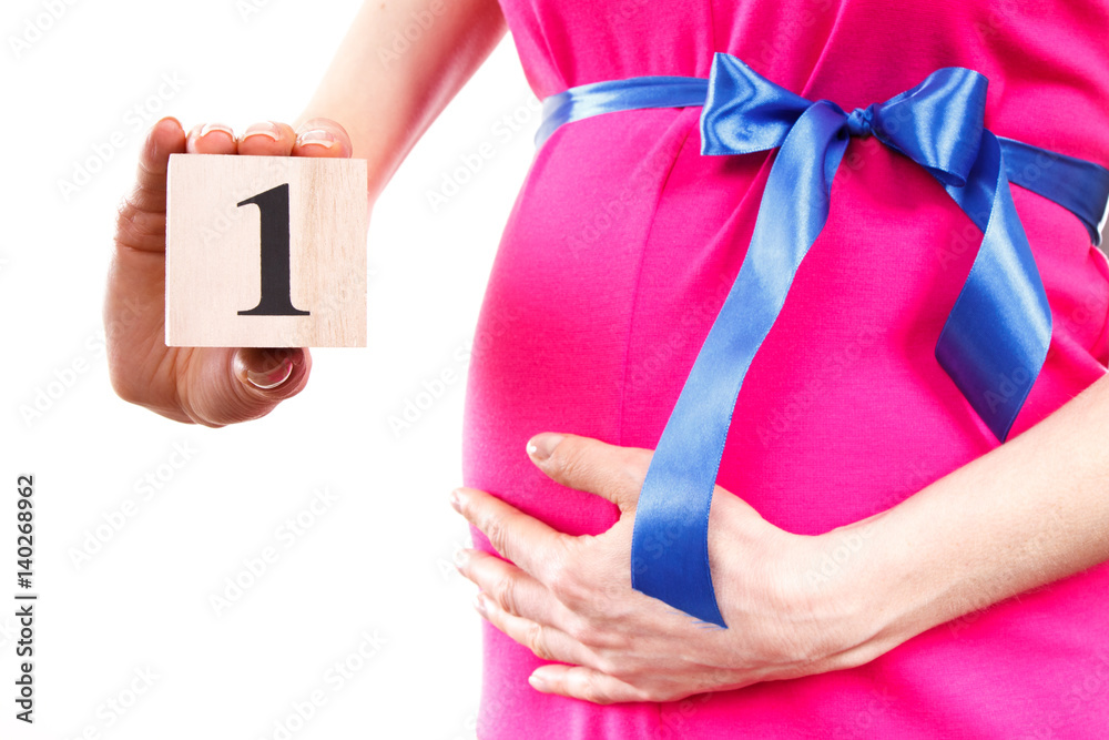 Fototapeta Hand of woman showing number of first month of pregnancy, expecting for newborn concept