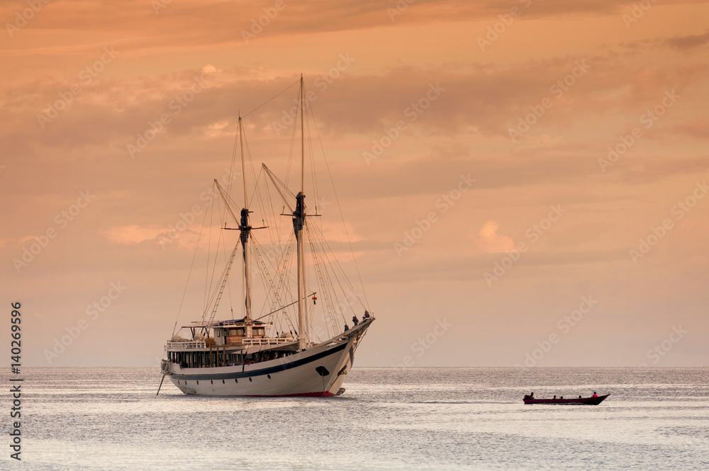 Indonesian Phinisi Schooner at Sunset. A traditional Phinisi schooner anchored off Waigeo Island in the Raja Ampat  area of West Papua, Indonesia.