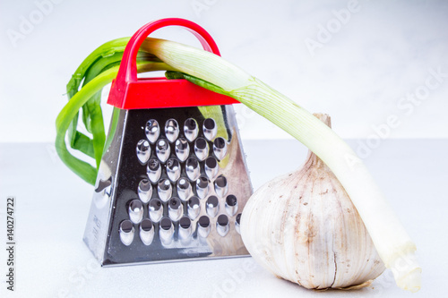 Still life: vegetables and fruits.apple, garlic, onion with small grater photo