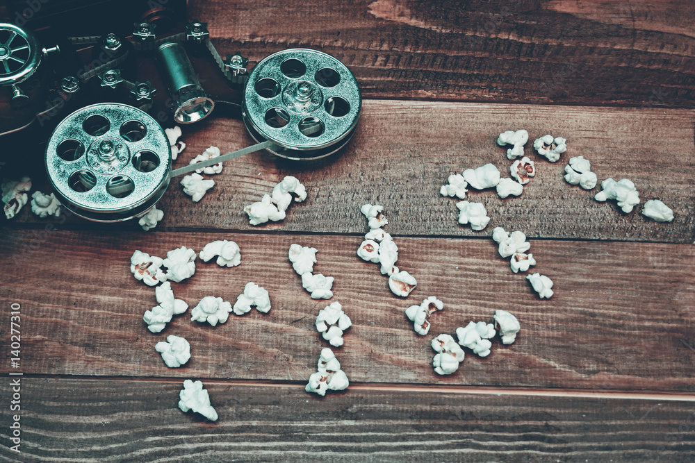 Fototapeta premium vintage music box in the shape of an old movie camera and popcorn. retro tones. copy space