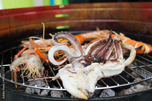 shrimp and squid grilled bbq seafood on stove photo