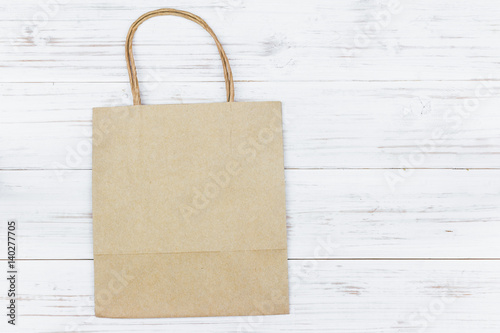 Paper bag on wooden background