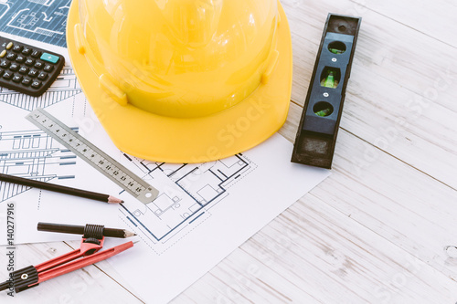 Construction tools with helmet safety on wooden background