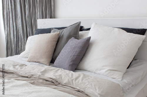 Bed with white and grey linens