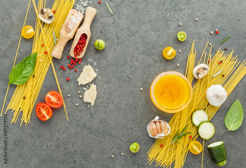 Italian food concept. Spaghetti with ingredients sweet basil ,tomato ,garlic peppercorn ,champignon,zucchini and parmesan cheese on dark background flat lay and copy space.