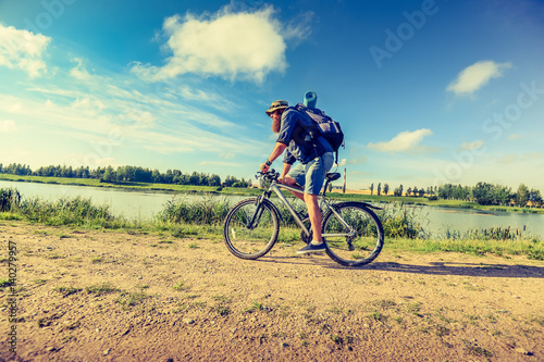 Fototapeta Naklejka Na Ścianę i Meble -  hipster man on a bicycle in the countryside