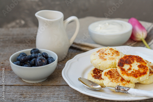Cottage cheese pancakes for breakfast with blueberries and sour cream.