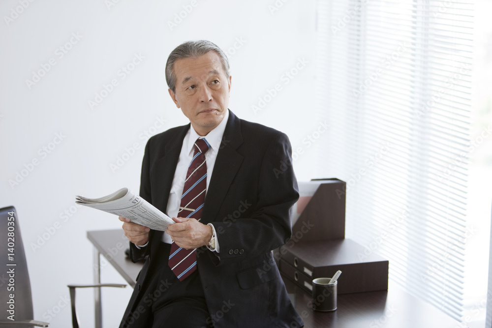 Mature Businessman with Newspaper Mature Businessman with Newspaper