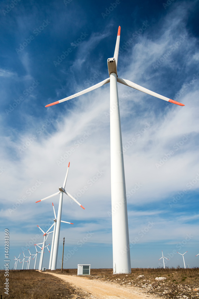 Wind turbines against a blue sky generating electricity Wind turbines against a blue sky generating electricity