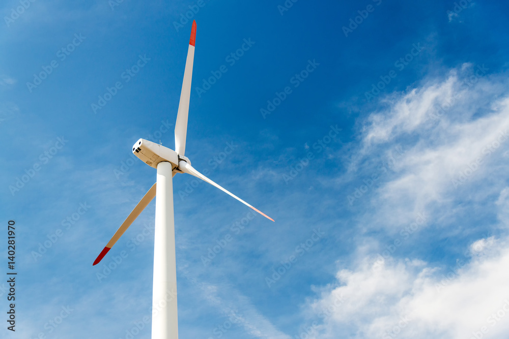 Wind turbines against a blue sky generating electricity Wind turbines against a blue sky generating electricity