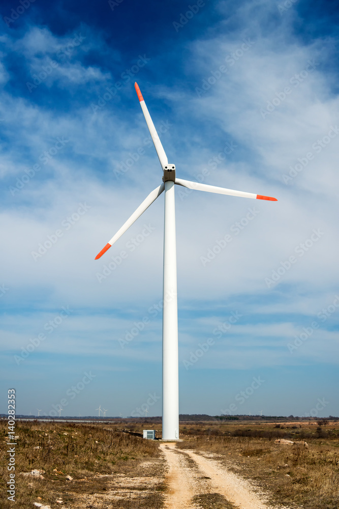 Fototapeta premium Wind turbines against a blue sky generating electricity