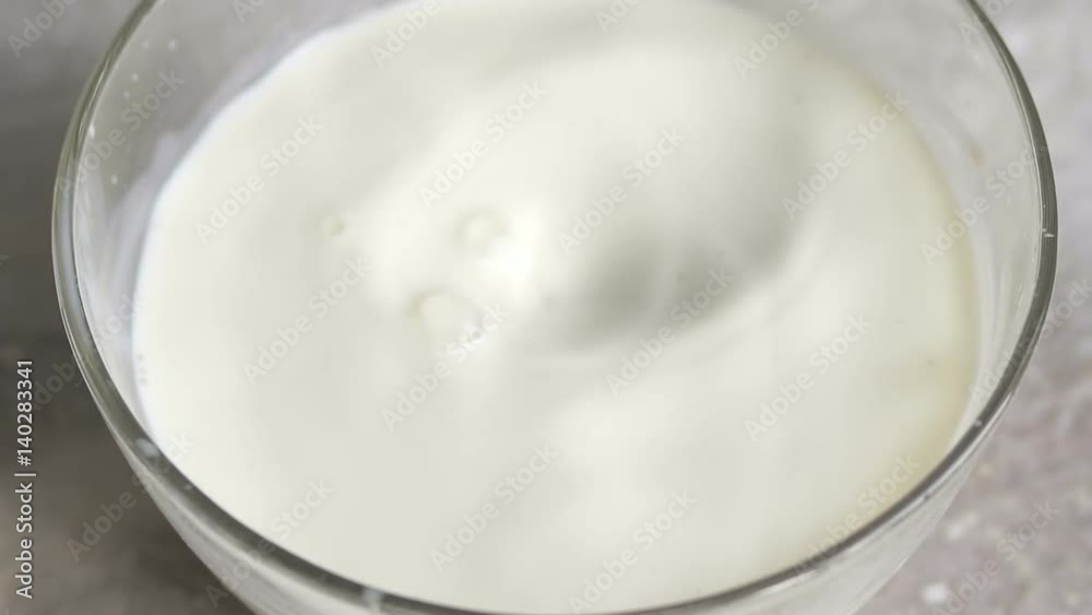 Fresh kiwi falling into the milk with a splash, slow motion. Kiwi in milk splash Fresh kiwi falling into the milk with a splash, slow motion. Kiwi in milk splash