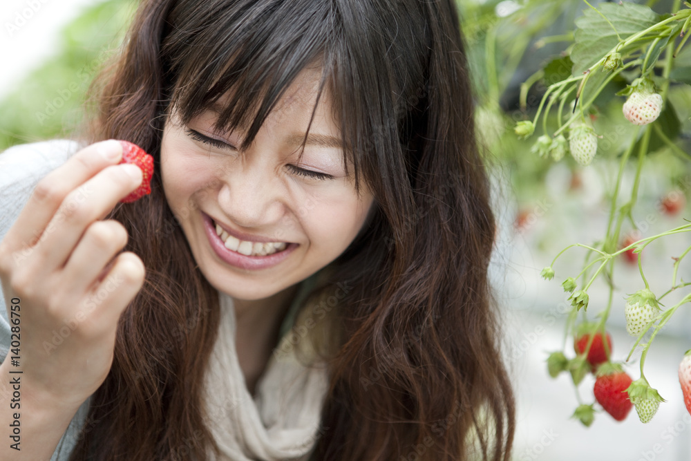 Young woman eating strawberry Young woman eating strawberry