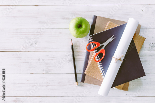 School books on wooden table, education concept photo