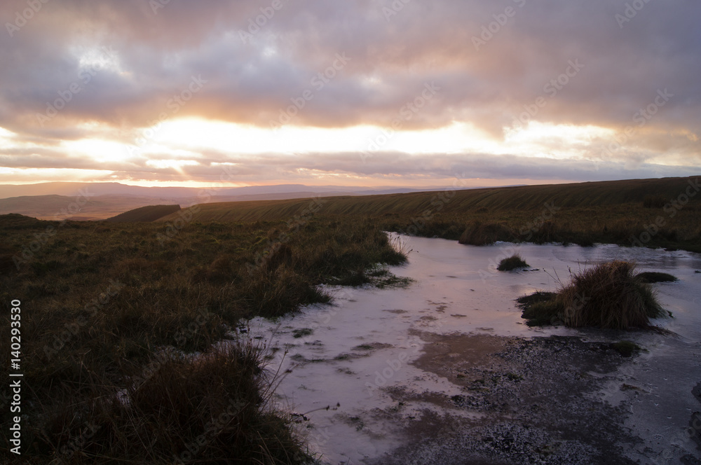 A winter sunset over a frozen bog in the Brecon Beacons