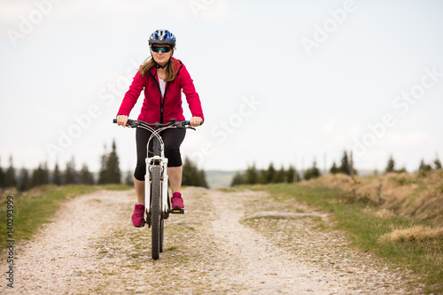 Middle-aged woman riding bicycle © Jacek Chabraszewski