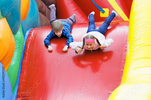 Brother and sister have fun in attraction