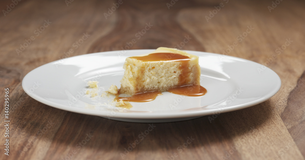 part of caramel cheesecake eaten with fork on wood table, 4k photo part of caramel cheesecake eaten with fork on wood table, 4k photo