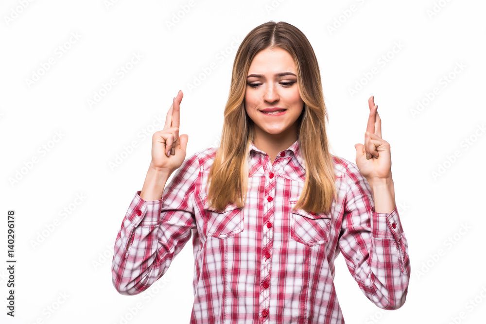 Portrait of young woman in plaid shirt with crossed fingers up on white Portrait of young woman in plaid shirt with crossed fingers up on white
