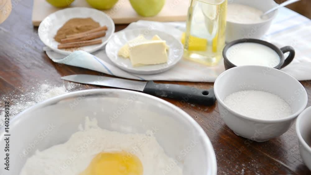 A man prepares a dough for baking buns and apple pie. A man prepares a dough for baking buns and apple pie.