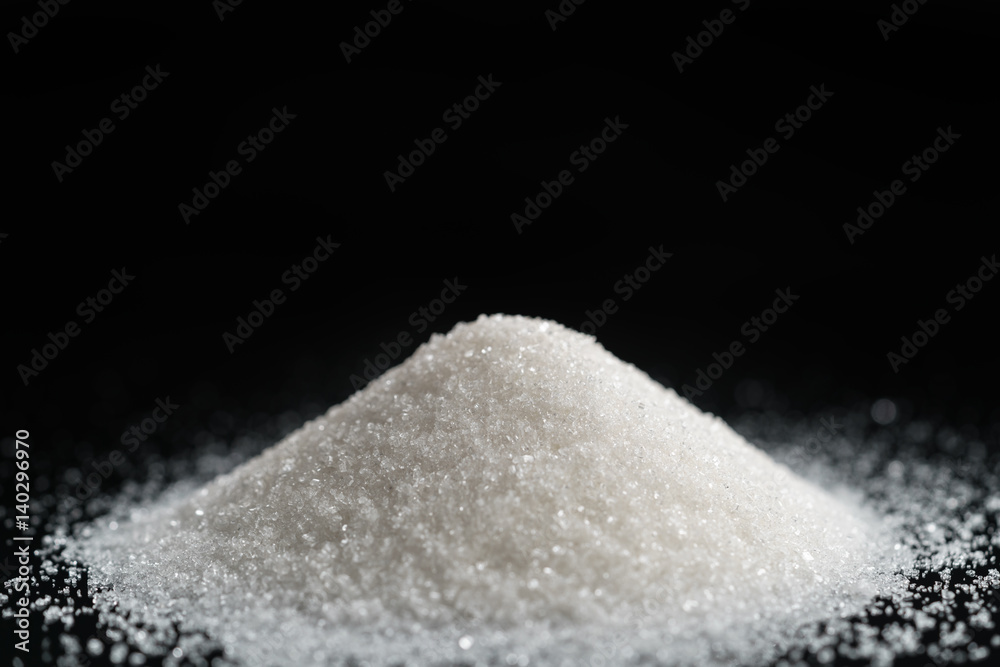 sugar pile on black background, closeup photo