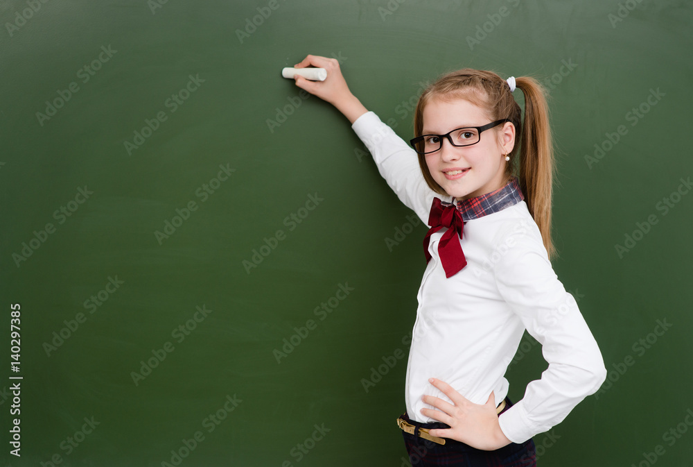 Schoolgirl wants to write something on the chalkboard