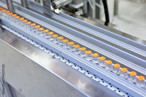 Sterile capsules for injection. Bottles on the bottling line of the pharmaceutical plant. Machine after checking sterile liquids. Interferon, nasoferon.