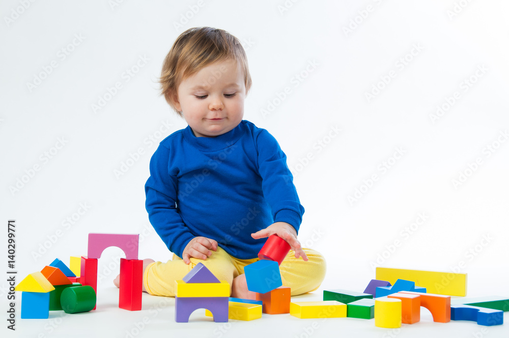 Little child playing with dices isolated on white background Little child playing with dices isolated on white background