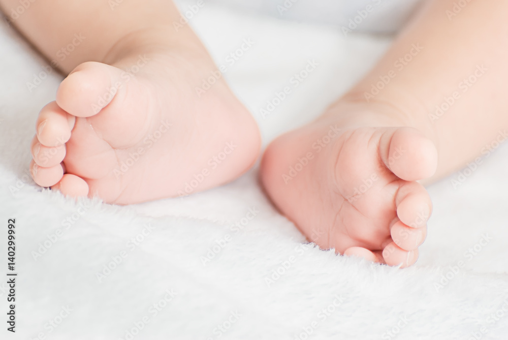 Close-up of mother hands holding tiny baby feet Close-up of mother hands holding tiny baby feet