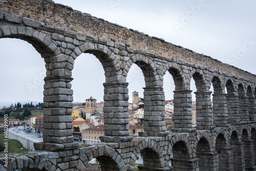A view to famous ancient roman aqueduct of Segovia and old buildings of the town, Castille and Leon, Spain.
