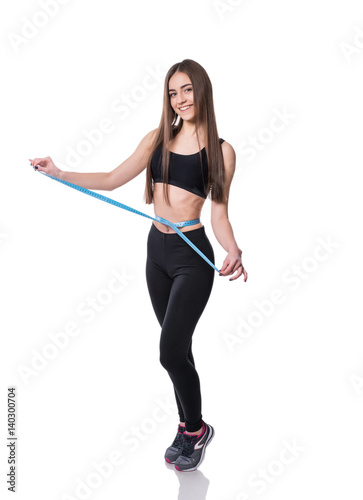 Slim and healthy young woman holding measure tape isolated on white background. Weight loss and diet concept.