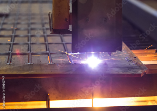Metal cutting laser. The laser beam cuts the sheet steel into billets.