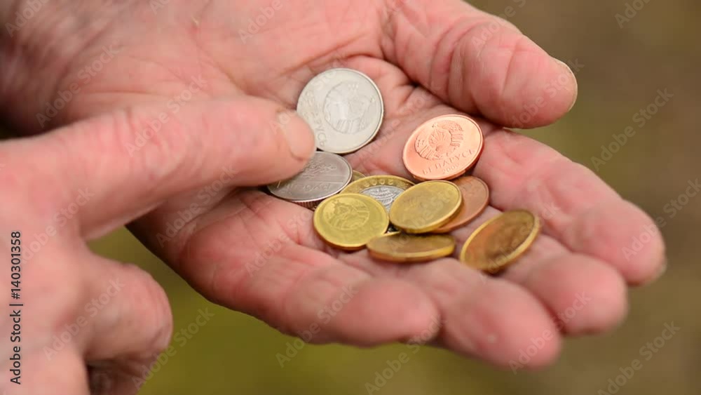 Coins in old woman hands. Elderly woman counting of small change coins. Business poverty concept. Coins in old woman hands. Elderly woman counting of small change coins. Business poverty concept.