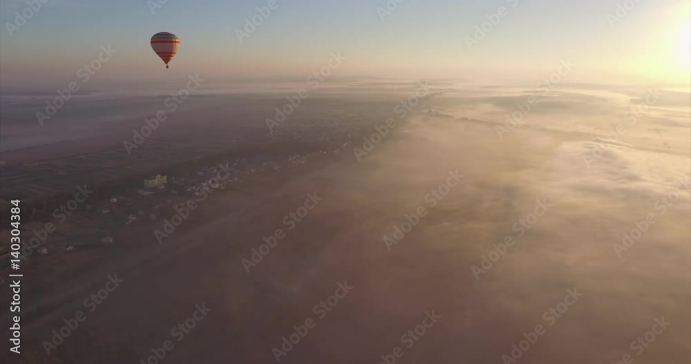 Aerial view of Hot air balloon floating in the pure blue sky on the sunrise Aerial view of Hot air balloon floating in the pure blue sky on the sunrise