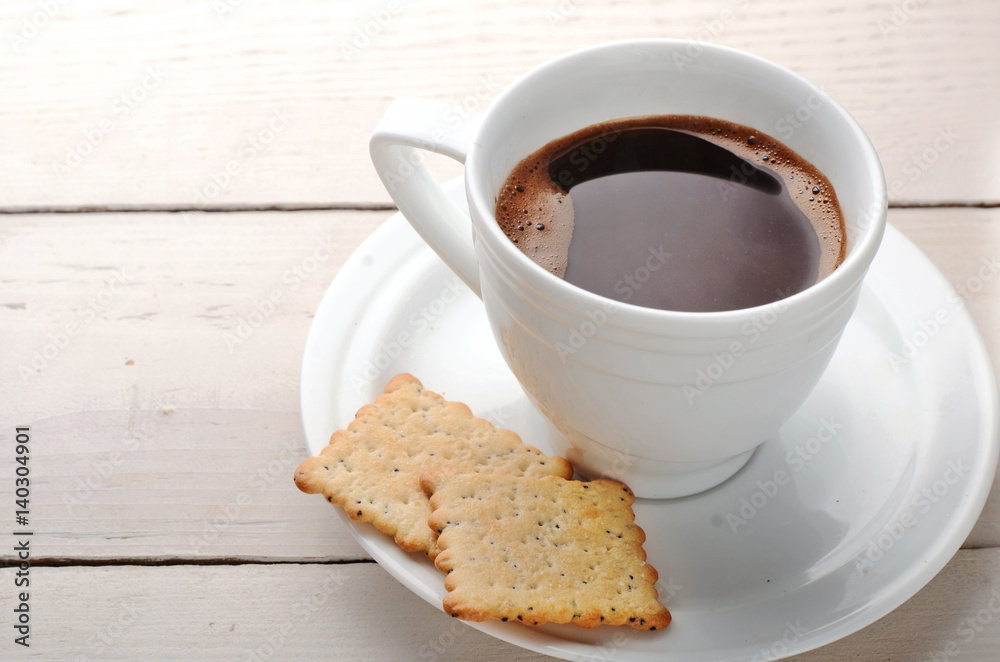 black coffee with biscuits on a wooden table black coffee with biscuits on a wooden table