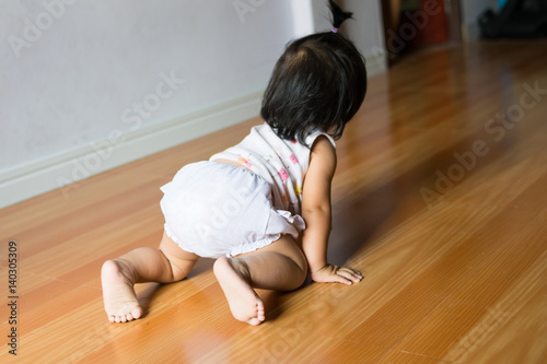 back view of children are learning to crawl