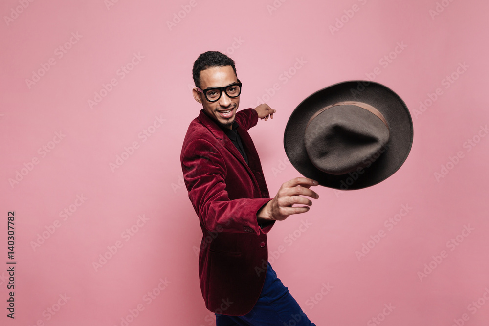 Portrait of a smiling afro american man throwing hat Stock Photo