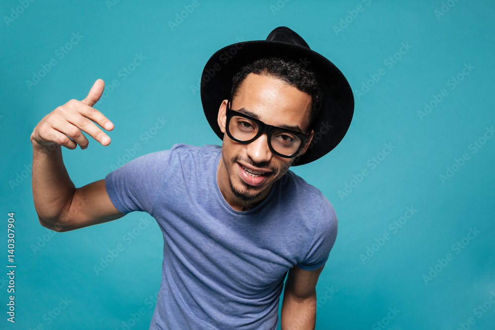 Fototapeta premium Portrait of a young casual afro american man in hat