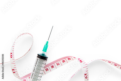 measuring tape and syringe on white background.isolated photo