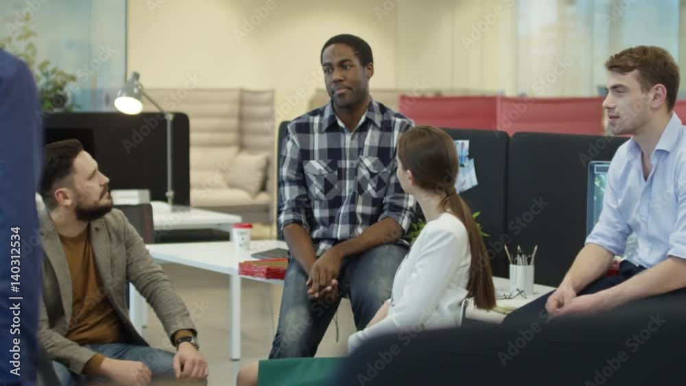 Young multicultural business team having an informal meeting in office