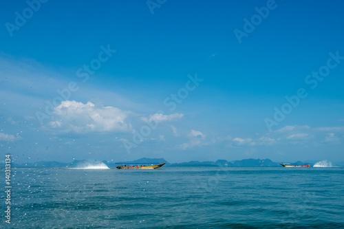 Fototapeta Naklejka Na Ścianę i Meble -  Unidentifiable longtail boats cruising in Phang Nga Bay, Thailand
