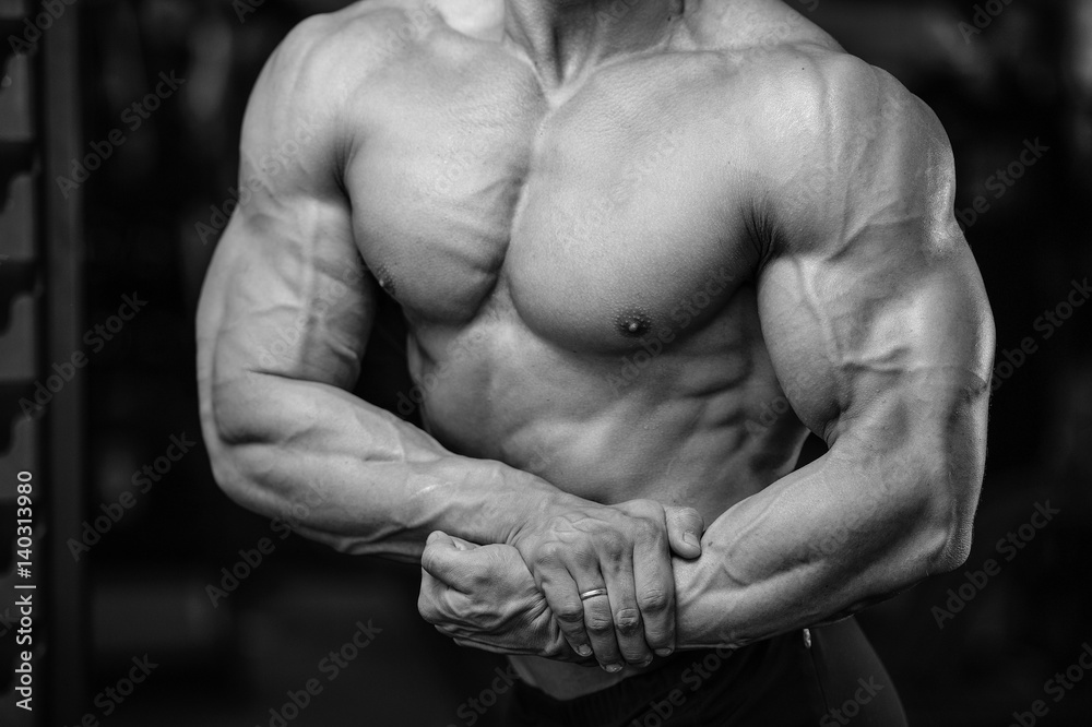 Handsome power athletic man on diet training pumping up muscles Handsome power athletic man on diet training pumping up muscles