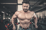 Brutal caucasian handsome fitness men on diet training chest pumping