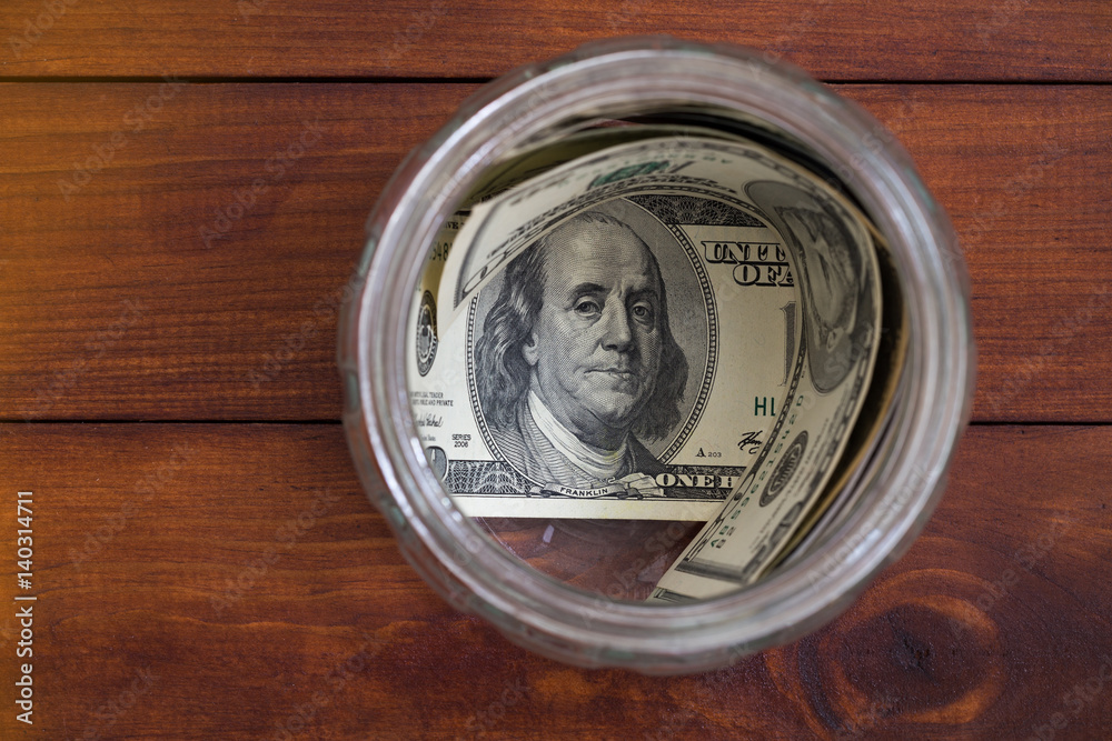 saving concept - money in glass jar saving concept - money in glass jar